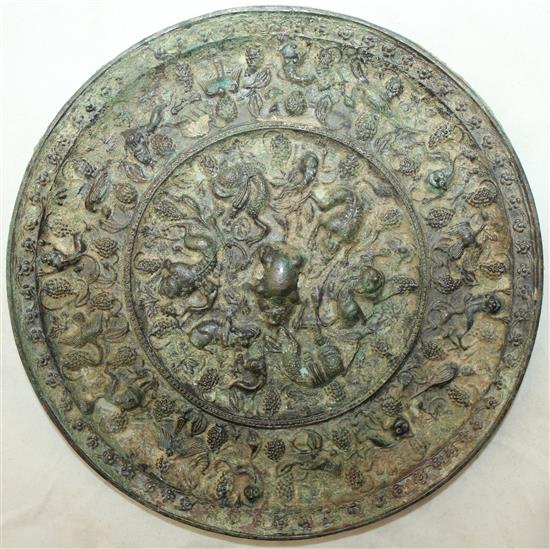 A Chinese bronze grapevine circular mirror, Tang Dynasty, 20.5cm